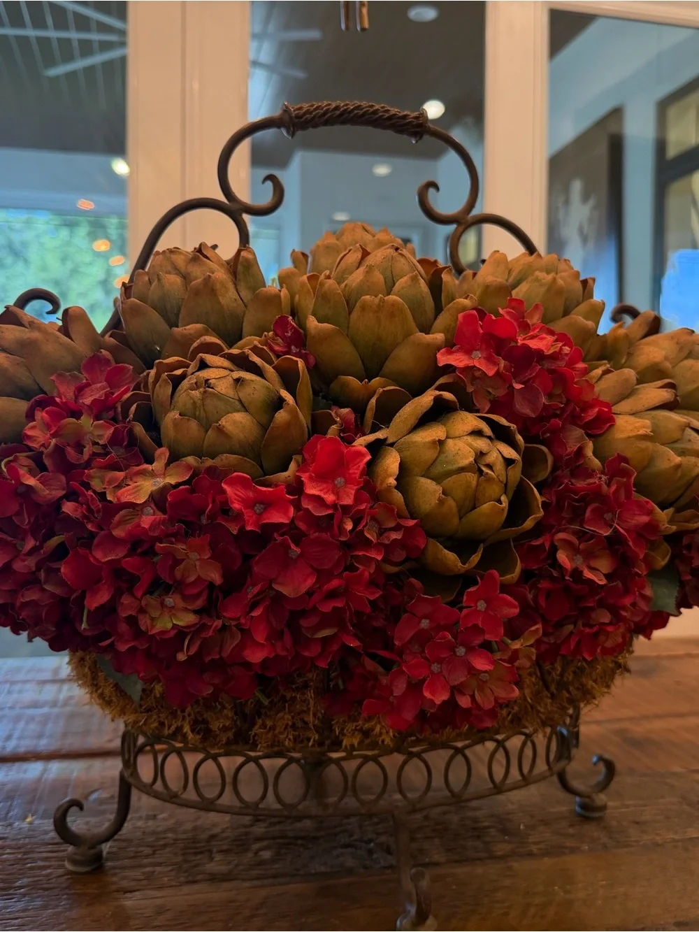 Rustic Iron Basket Centerpiece with Green Artichoke and Red Hydrangea Accents